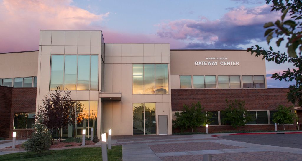 exterior of the Gateway Center as seen from the upper parking lot with a purple sunset sky