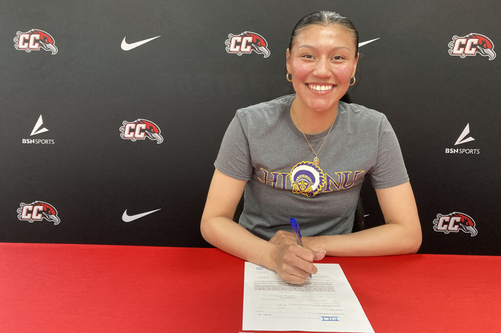 Photo of Angela Astorga signing her letter of committment.
