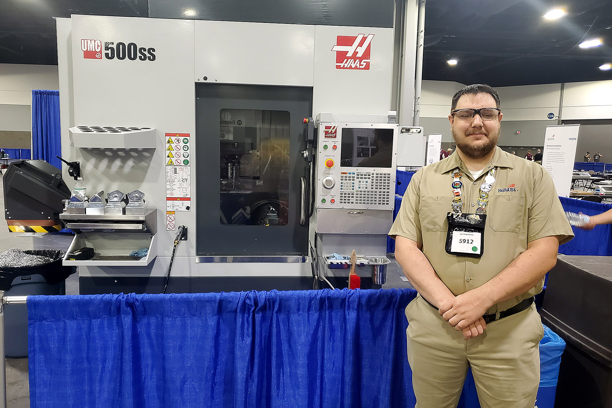 Casper College student Alex Brown poses in front of a CNC programming machine at the SkillsUSA Championships held in Atlanta.