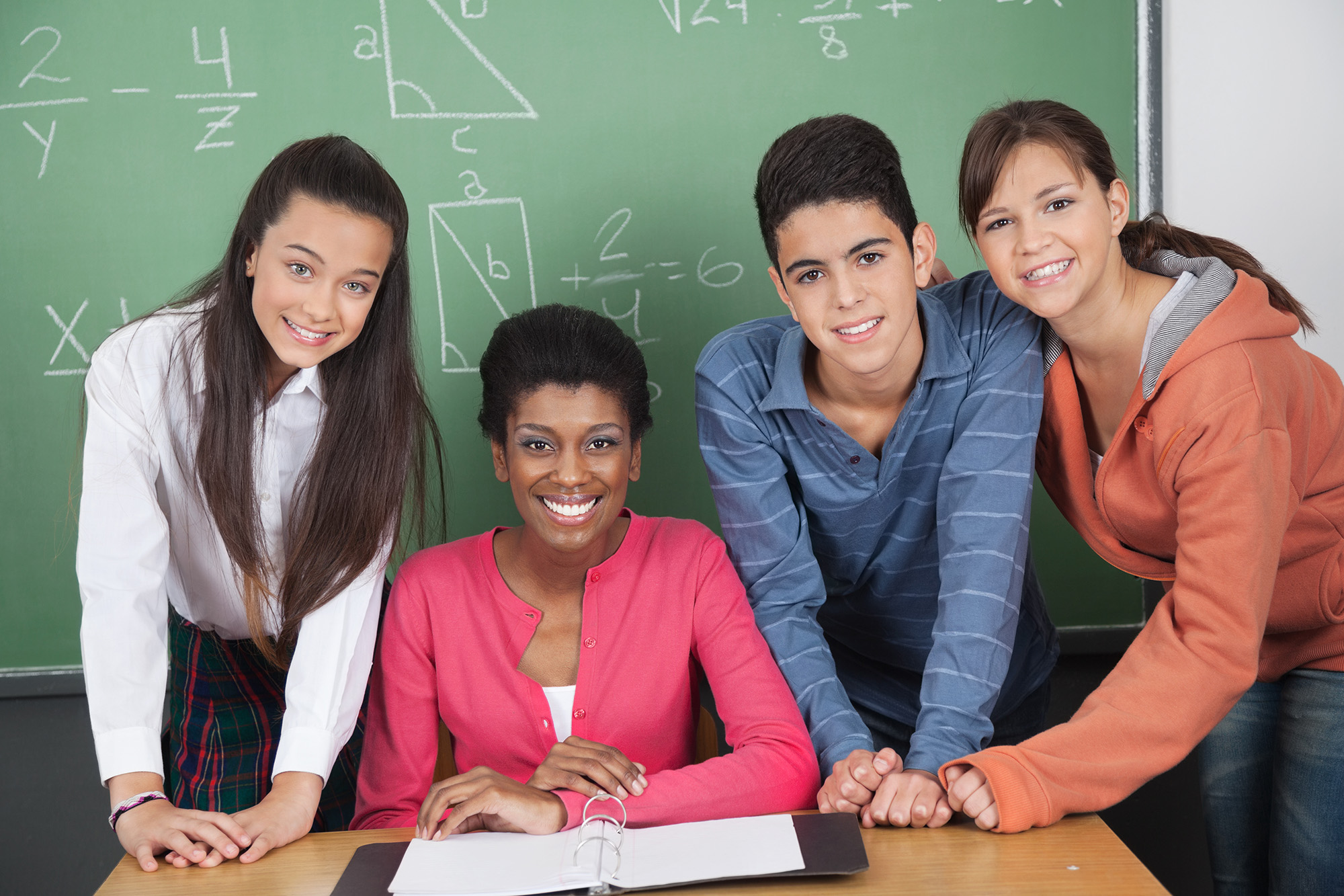 Photo of teacher and three students for professional development for teachers press release.