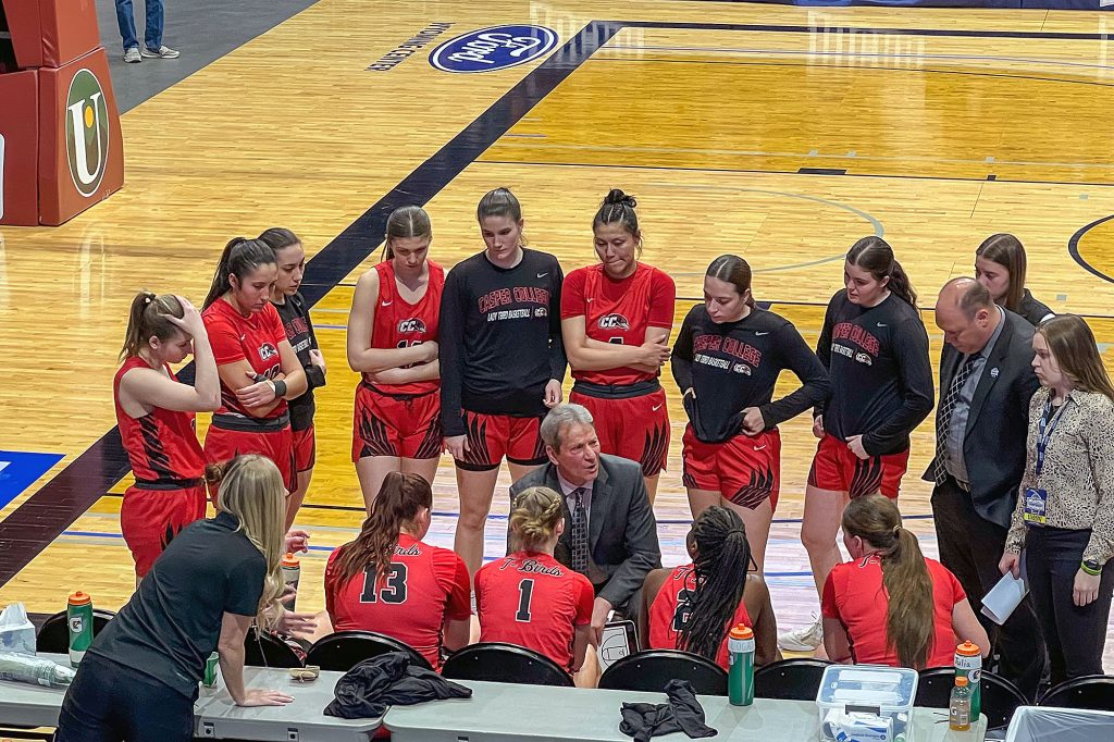 Casper College Women's Head Basketball Coach explaining the plan for their upcoming game during the NJCAA National Women's Basketball Championship in March 2024.