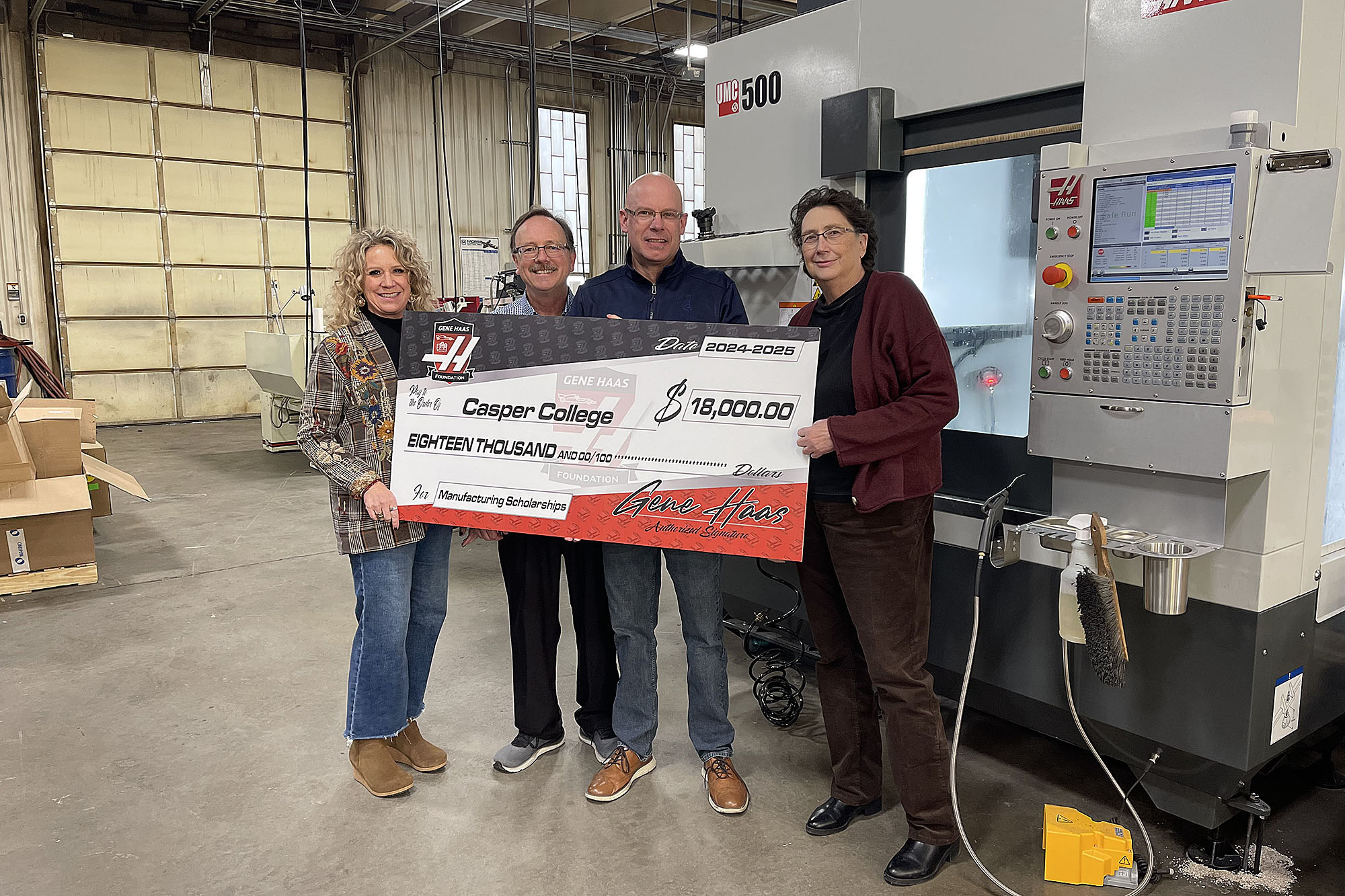 Photo of Casper College receiving a check for $18,000 for scholarships for student in manufacturing. Pictured l-r, Rachel Chadderdon, Paul Brutsman, John Bonewitz, and Katie McMillan.