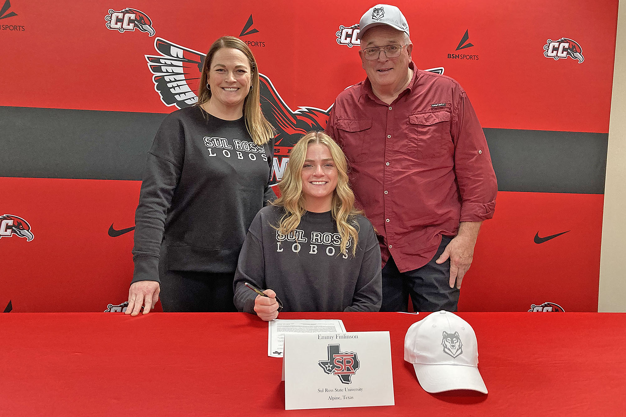 Emmy Finlinson, center, poses with her mother and grandfather after siging her intent to play soccer at Sul Ross State University this fall.