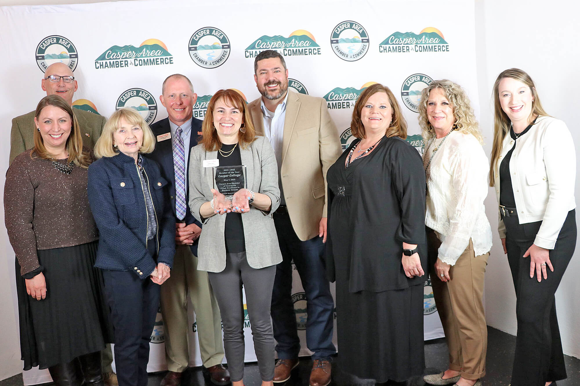 Photo of Casper College employees with the award the school won from the Casper Area Chamber of Commerce in recognition of the college being named the Chamber's Member of the Year.