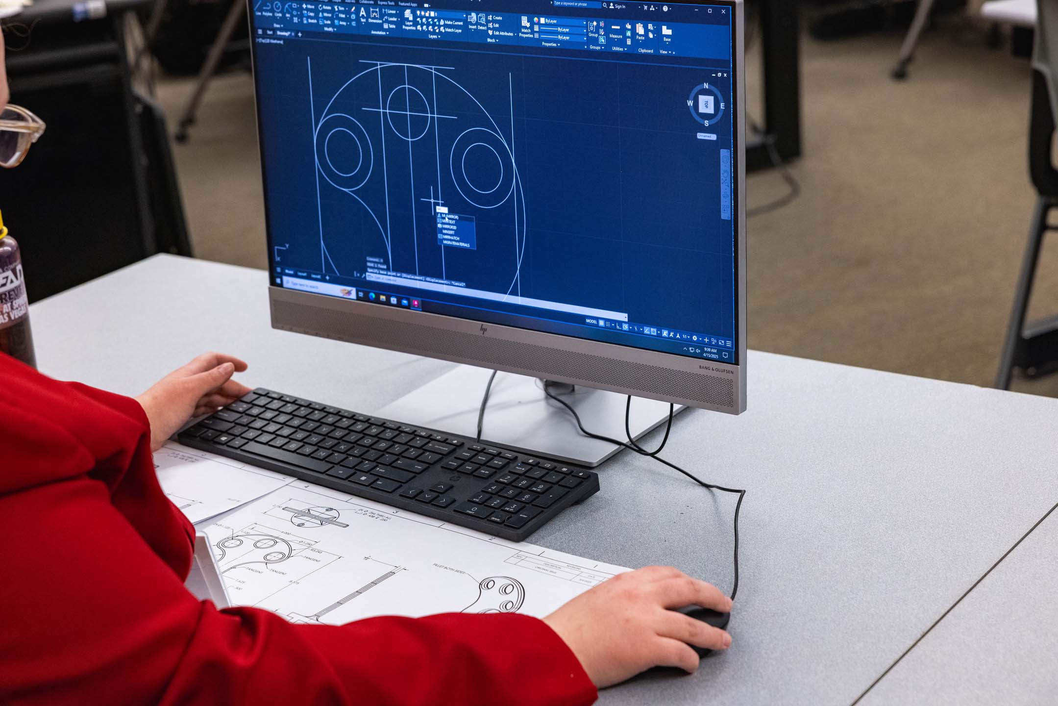 A student sitting in front of a computer working in an engineering class