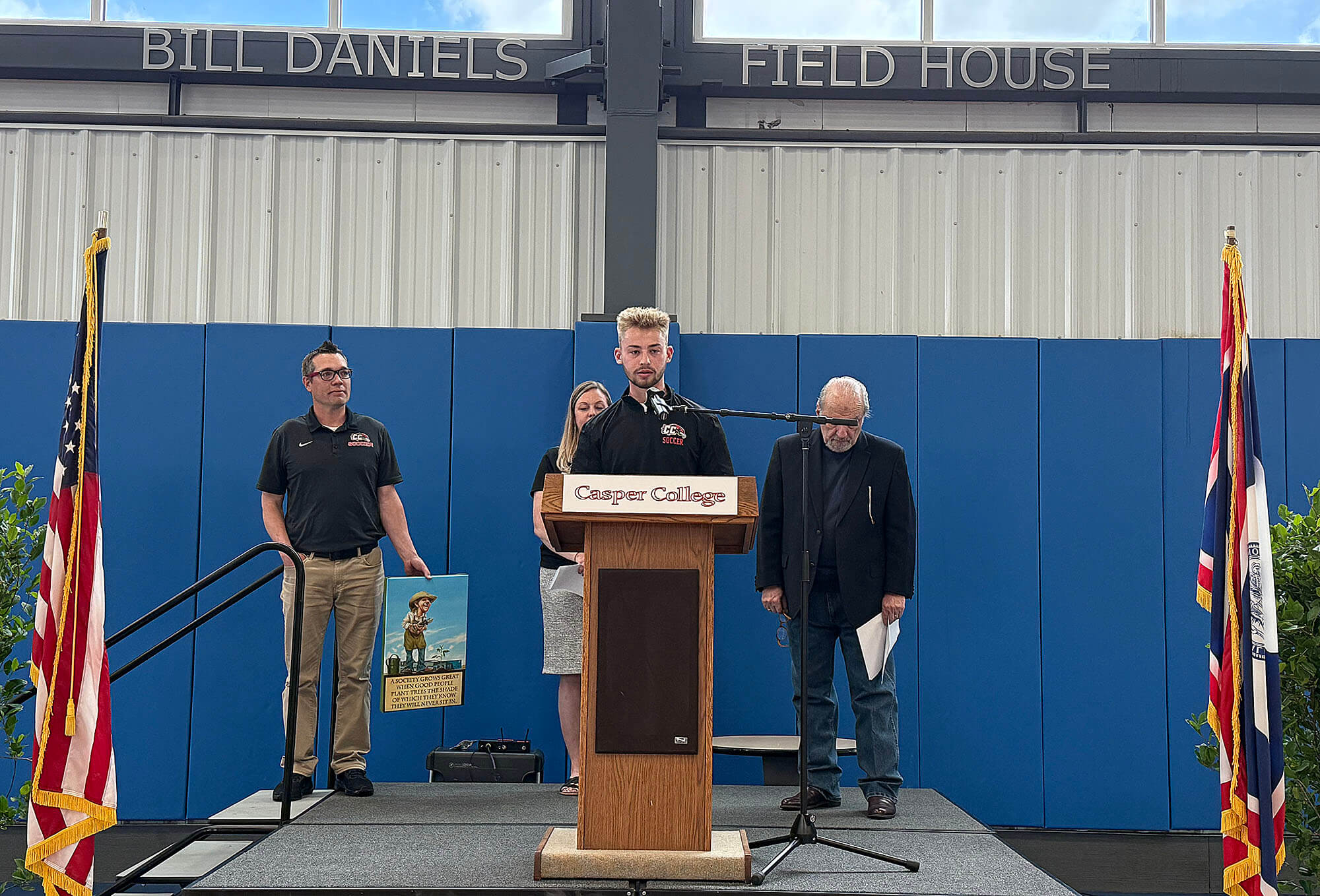 Photo of Paxton Stoneking giving acceptance speech for a YMCA award to the Casper College athletics department.