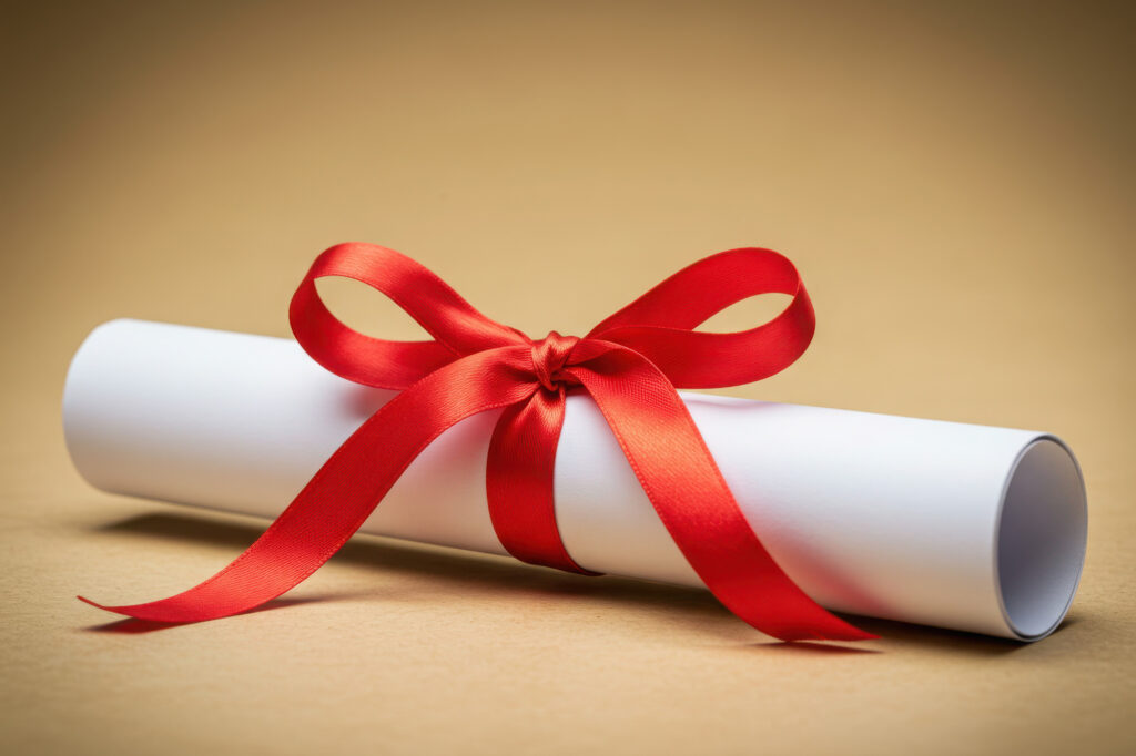 A white diploma scroll with a red ribbon, symbolizing the academic success of students on the Fall 2025 Dean's Honor Roll.