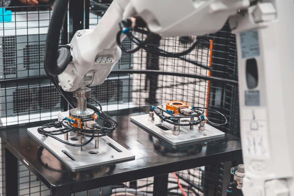 Robotic arm working on a production line with metal components manufacturing parts.