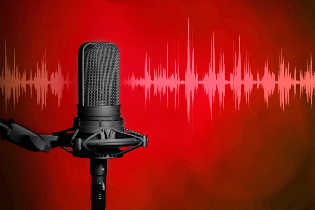 A professional black condenser microphone for the Casper College Alumni Association Awards nomination announcement, featuring a red soundwave background.
