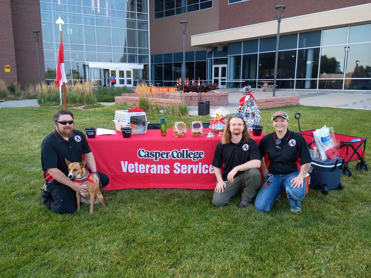 veterans services table outside with members and pets
