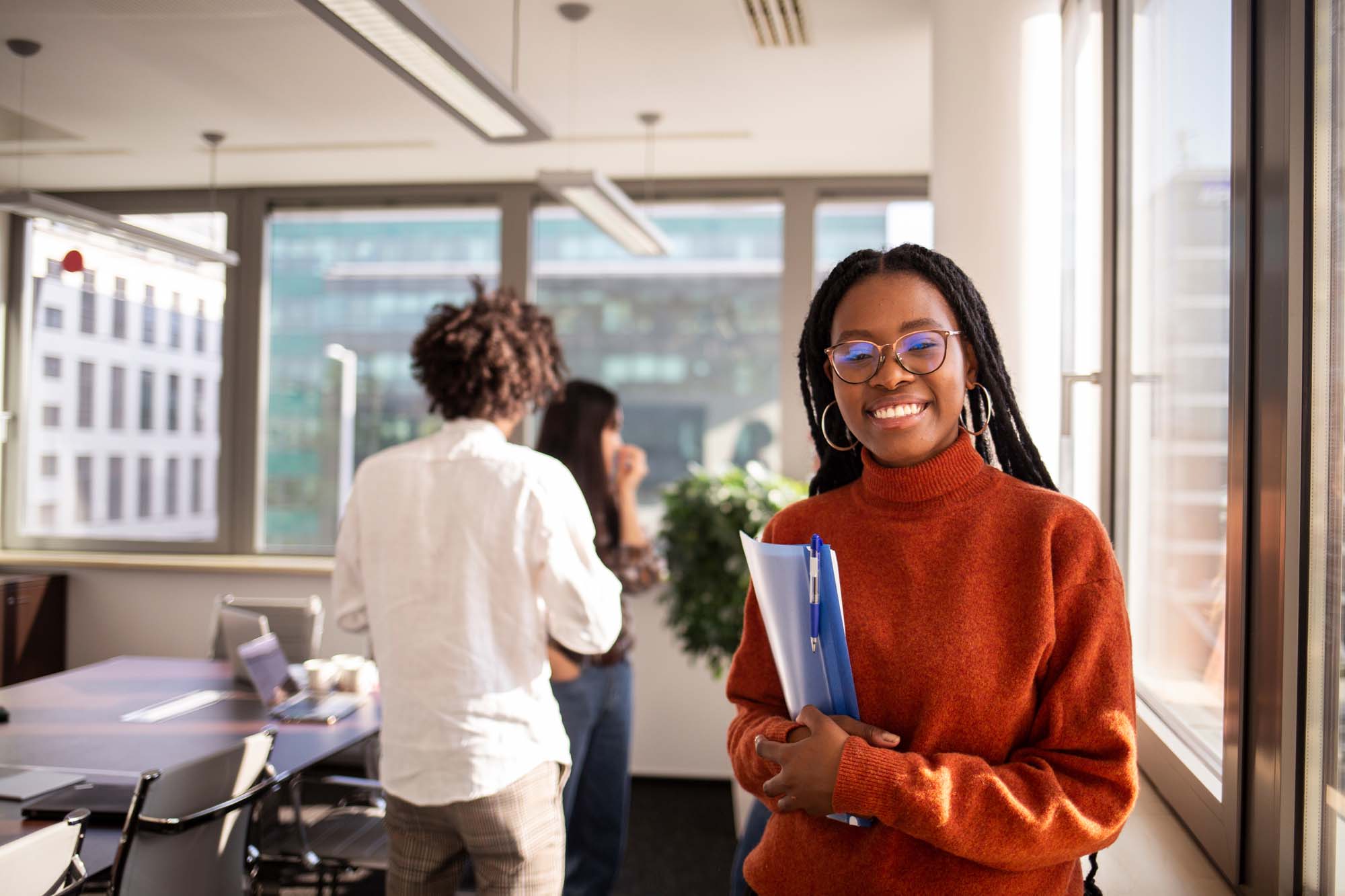 a smiling student in a well lit classroom