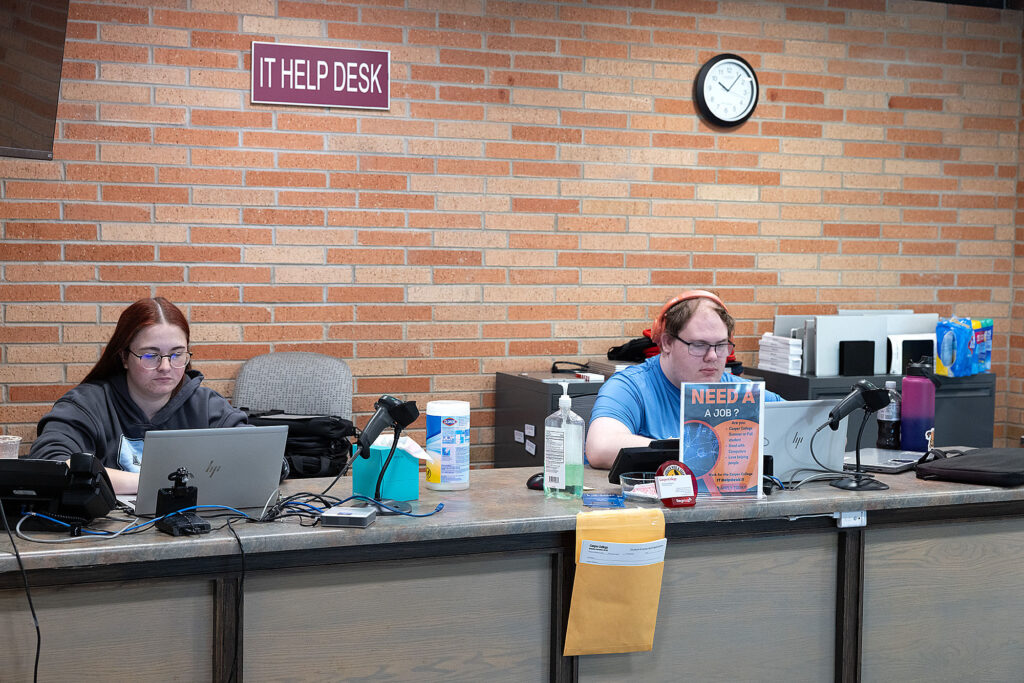 Two Casper College students working at the IT Help Desk on campus.