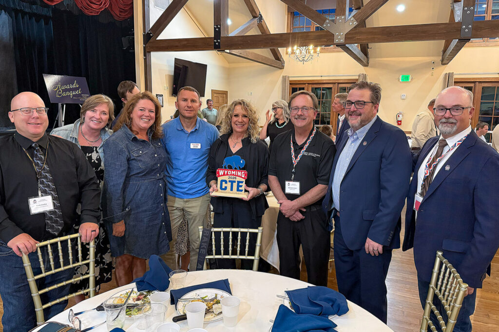 Rachel Chadderdon holding the WACTE Administrator of the Year award with Casper College colleagues.