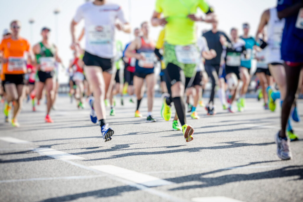 Runners' legs in motion during a road race representing the T-Bird Trek at Casper College.
