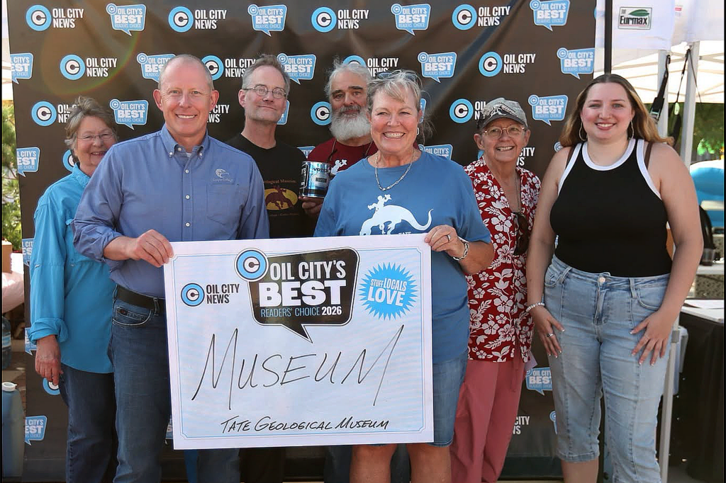 Staff and volunteers at the Tate Geological Museum holding the Oil City's Best Museum award.