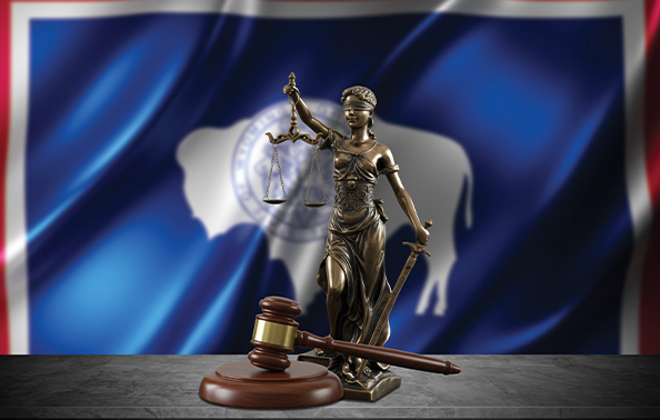 Wyoming Supreme Court judicial symbols featuring bronze Lady Justice statue and gavel