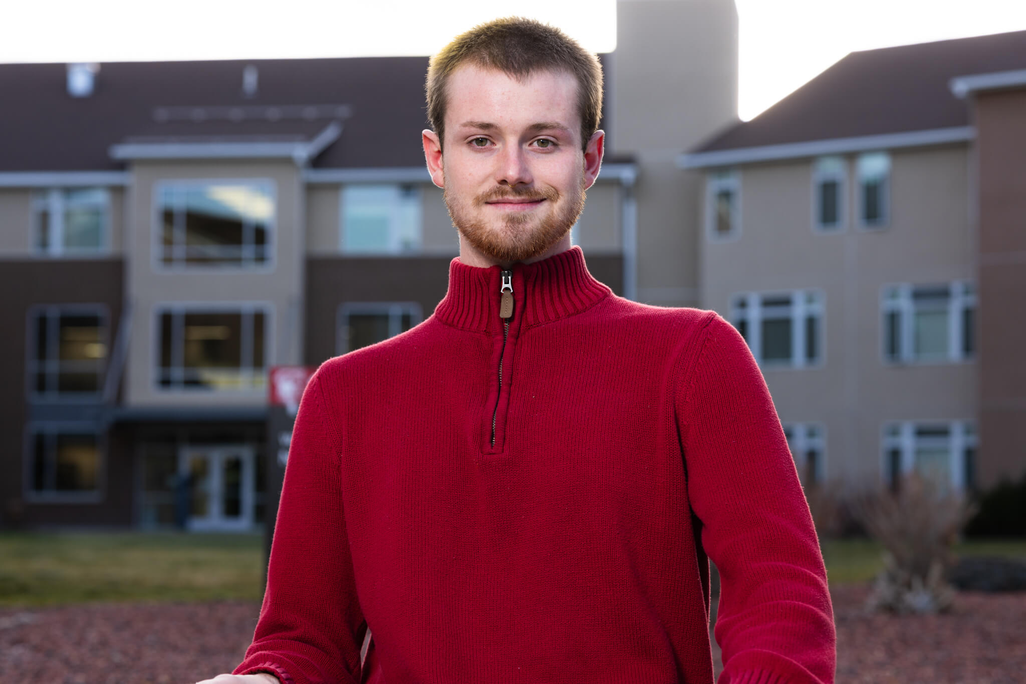 Voyager Scholarship recipient Dayton Stone standing outdoors in front of the Residence Hall at Casper College.