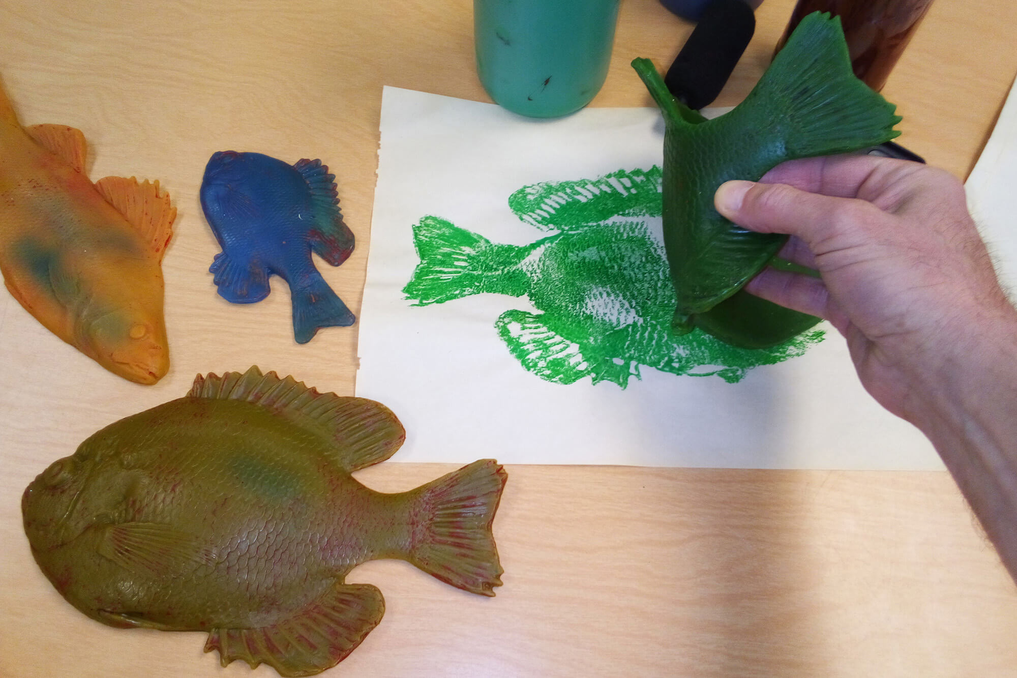Tate Saturday Club gyotaku fish printing demonstration with colorful rubber fish molds and green ink print on paper